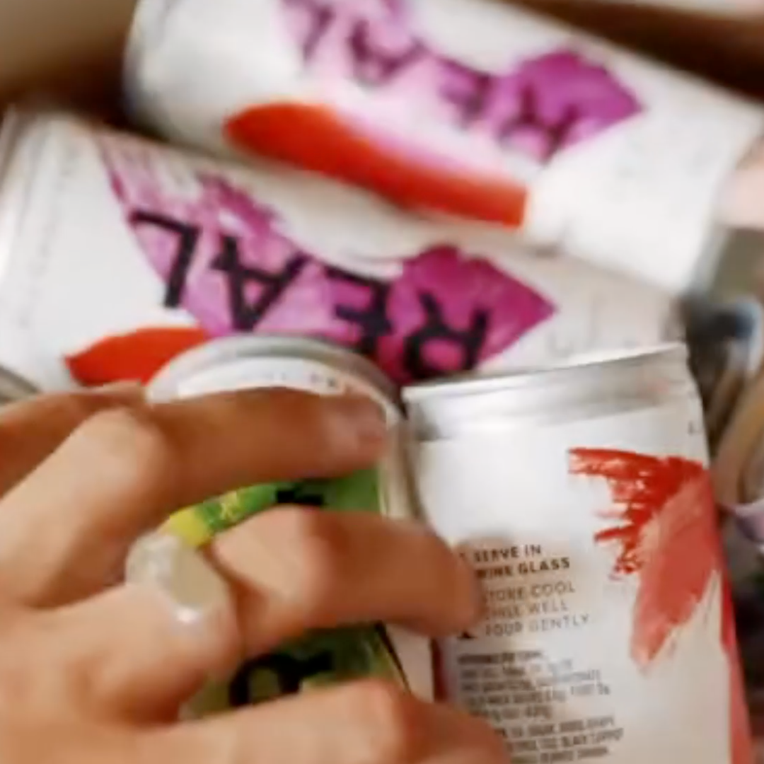 REAL-Alcohol-Free-Tours-And-Tastings-Main-Image-Cans-and-Hands