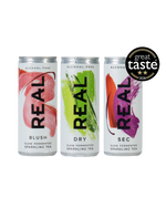 Three aluminum cans of REAL Sparkling Tea on a white background, with a black 'great taste 2026' badge in the top right. The cans are labeled BLUSH, DRY, and SEC, with pink, green, and orange-red abstract designs on white backgrounds.