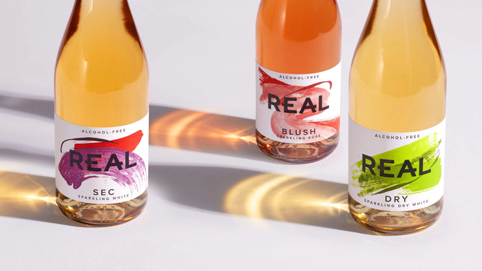 REAL Sec (Formerly Royal Flush), REAL Blush (Formerly Peony Blush), And REAL Dry (Formerly Dry Dragon) Bottle Trio, Homepage Hero